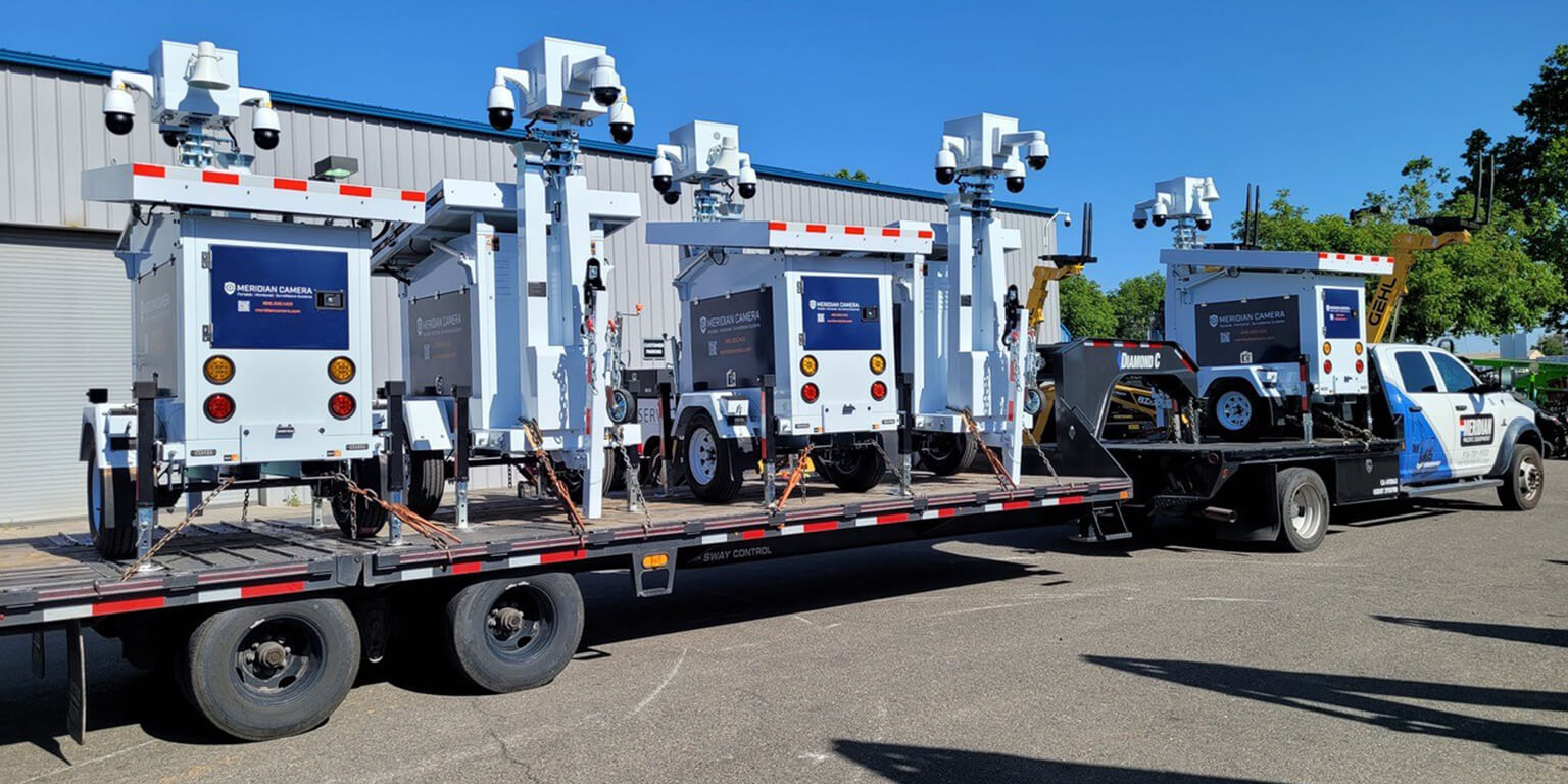 Meridian Hauling Service truck hauling surveillance cameras