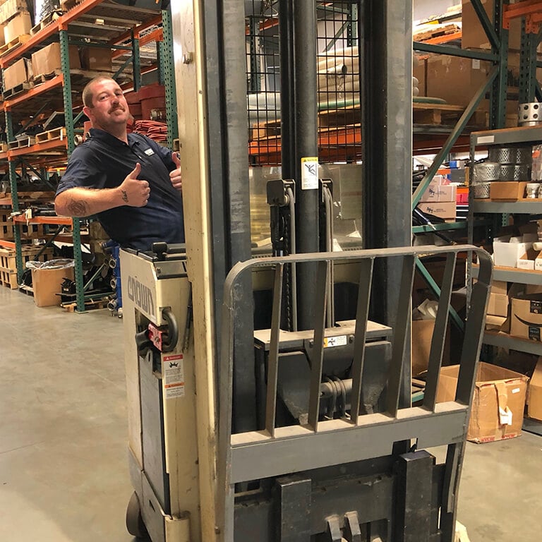 Staff in warehouse on forlift
